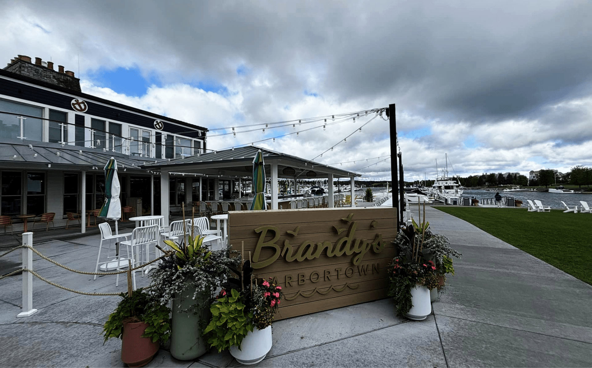460336609_122100814946528389_807522213871416755_n Brandy’s Harbortown waterfront restaurant and lounge with outdoor seating, string lights, and marina views in Northern Michigan.